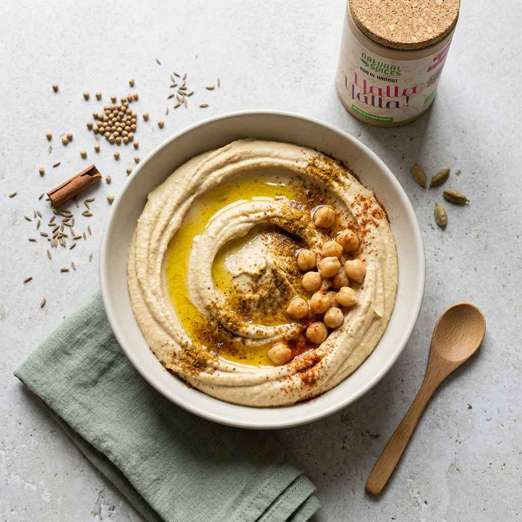 a bowl of ras el hanout hummus with yalla yalla ras el hanout spice mix